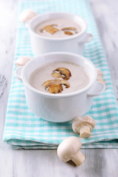 Mushroom soup in white pots, on napkin,  on wooden background — Stock Photo, Image