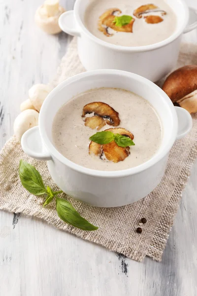 Mushroom soup in white pots, on napkin,  on wooden background — Stock Photo, Image