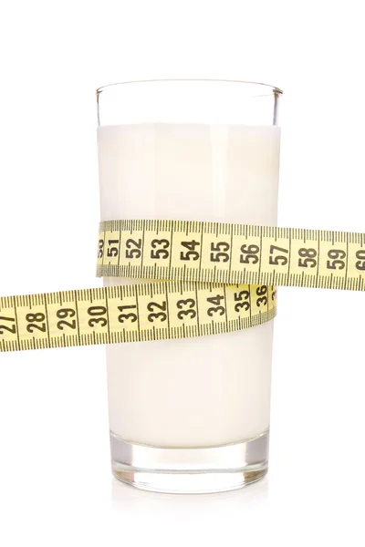 Glass of milk with measuring tape isolated on white — Stock Photo, Image