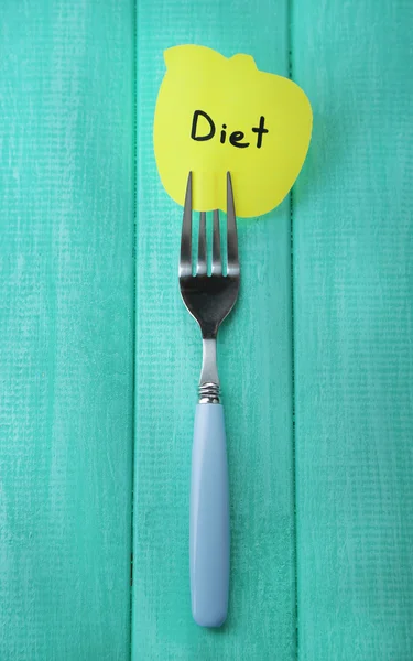 Note paper with message  attached to fork, on  color wooden background — Stock Photo, Image