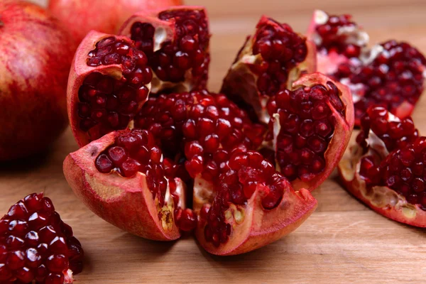 Ripe pomegranates on table close-up — Stock Photo, Image