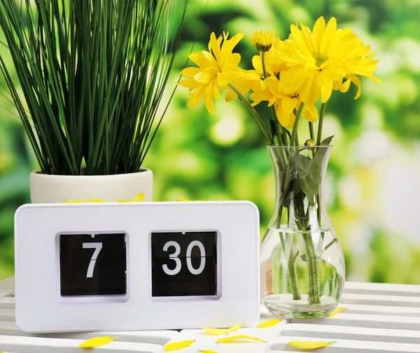 Digital alarm clock on table, on nature background — Stock Photo, Image