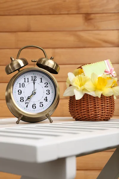 Alarm clock on table, on wooden background — Stock Photo, Image