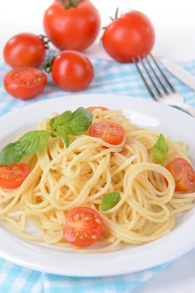 Delicious spaghetti with tomatoes on plate on table close-up Royalty Free Stock Images