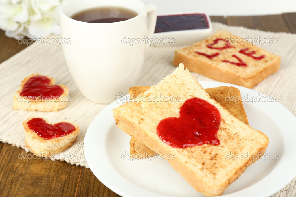 Delicious toast with jam and cup of tea on table closeup — Stock Photo