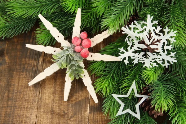 Mooie sneeuwvlokken met fir branch op houten achtergrond — Stockfoto