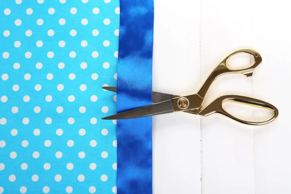 Scissors on color fabric background — Stock Photo, Image