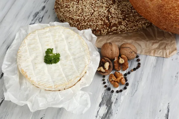 Chutný italský sýr a chléb na dřevěný stůl — Stock fotografie