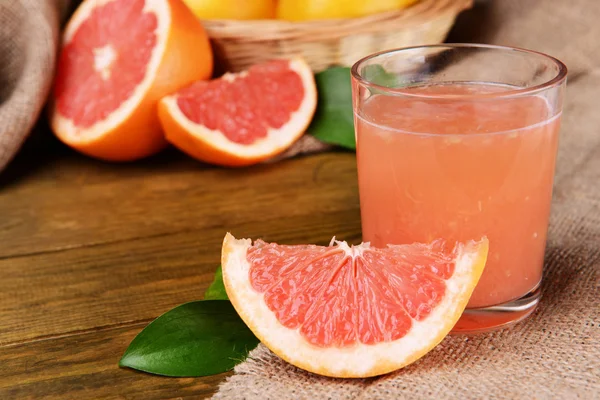 Pompelmo maturo con succo sul tavolo primo piano — Foto Stock