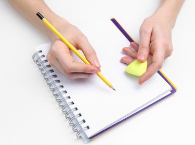 insan eli kalem ve erase kauçuk ve defter, üzerinde beyaz izole