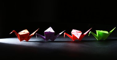ışık ile karanlık arka plan üzerinde Origami Vinçler