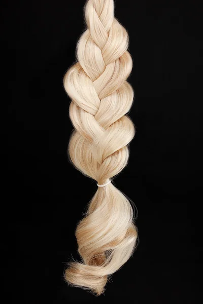 Blond hair braided in pigtail isolated on black — Stock Photo, Image