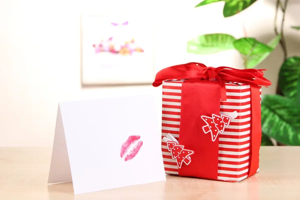 Gift with card for loved one on table on room background — Stock Photo, Image