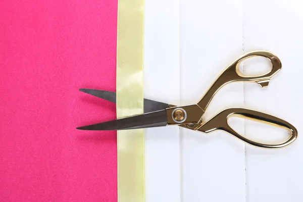 Scissors on color fabric background — Stock Photo, Image