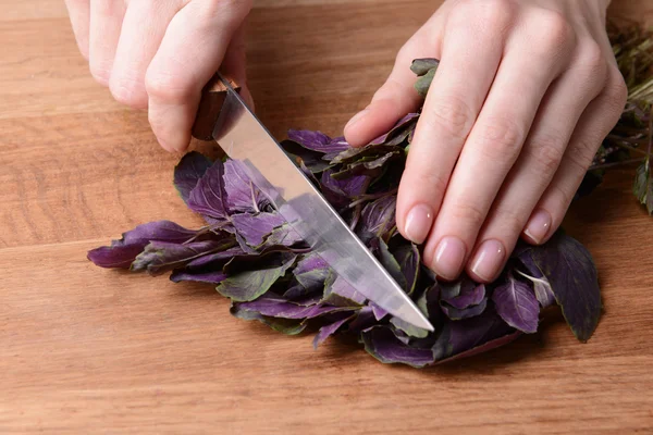 Chopped basil on wooden board close-up — Stock Photo, Image