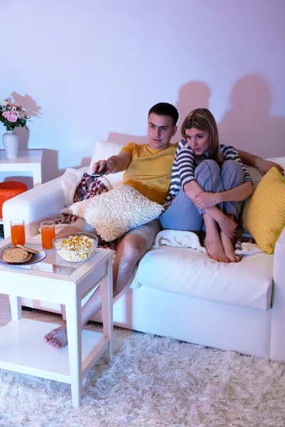 Young couple watching television at home of blacking-out — Stock Photo, Image