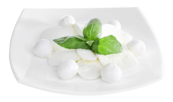 Tasty mozzarella cheese with basil on plate isolated on white — Stock Photo, Image