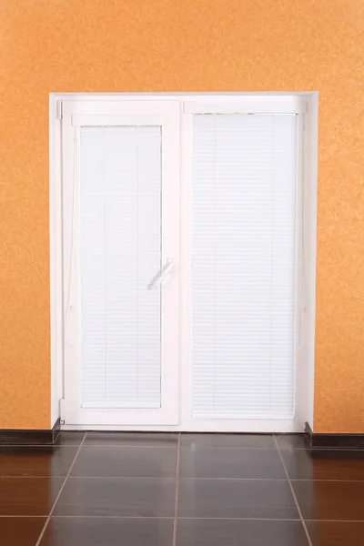 White plastic door with closed blinds — Stock Photo, Image