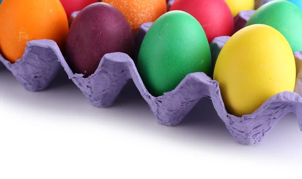 Colorful Easter eggs in tray isolated on white — Stock Photo, Image