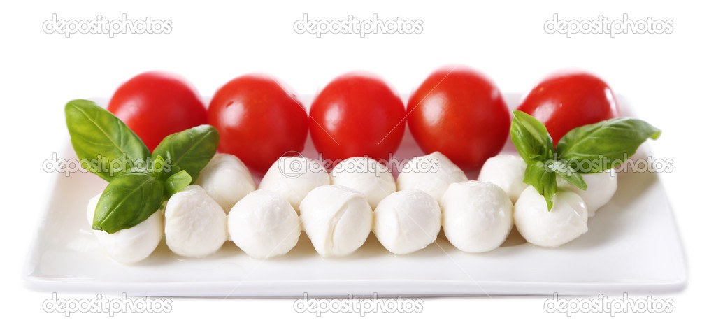 Tasty mozzarella cheese balls with basil and red tomatoes, isolated on white