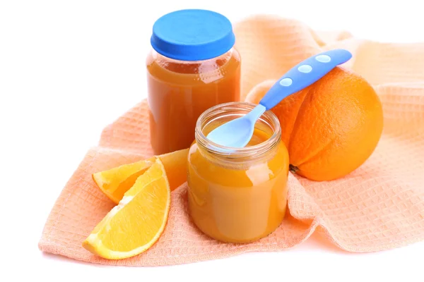 Jars of various baby food with orange, isolated on white — Stock Photo, Image