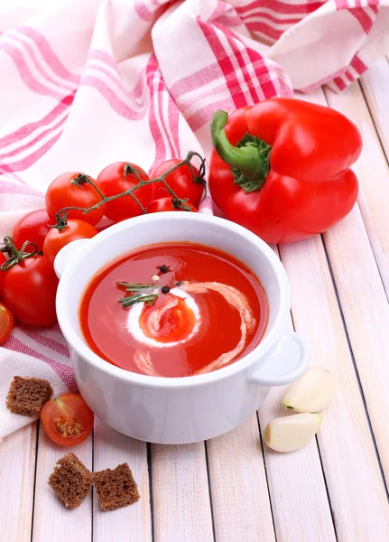 Tasty tomato soup and vegetables on wooden table — Stock Photo, Image