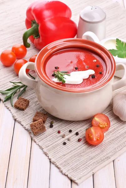 Tasty tomato soup and vegetables on wooden table — ストック写真