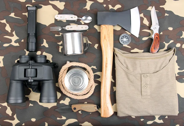 Equipo para trekking sobre fondo de camuflaje —  Fotos de Stock