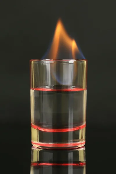 Glass with burning alcohol on black background — Stock Photo, Image