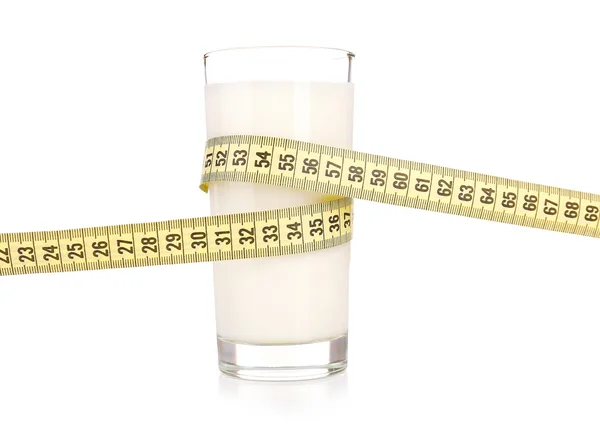 Glass of milk with measuring tape isolated on white — Stock Photo, Image