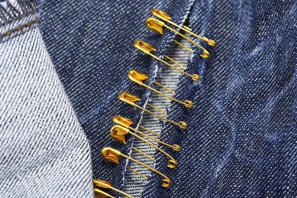 Safety pins on fabric background — Stock Photo, Image