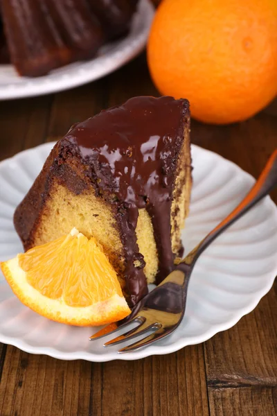 Pedazo de delicioso pastel con naranjas en primer plano de la mesa — Foto de Stock
