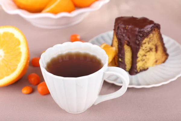 Pedaço de bolo delicioso com laranjas na toalha de mesa close-up — Fotografia de Stock