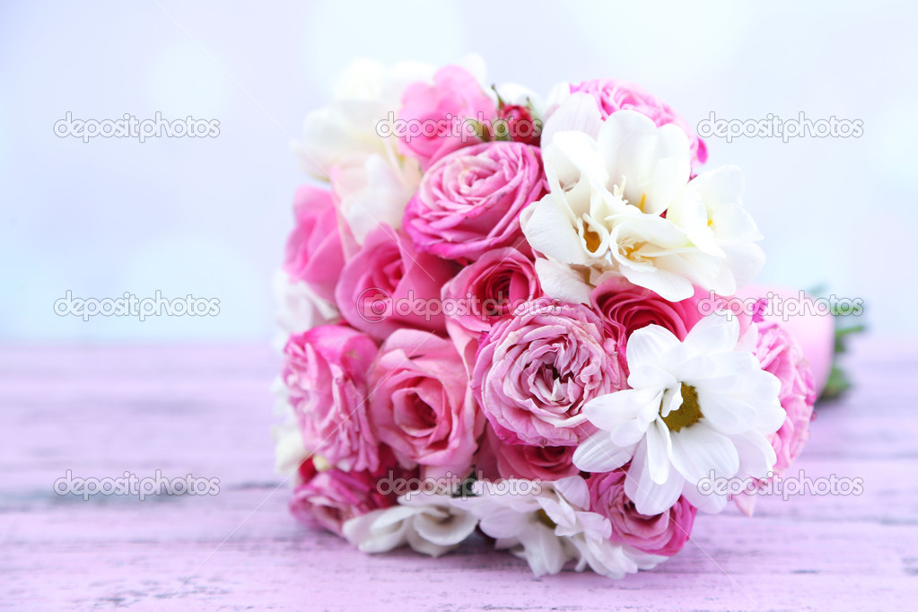 Beautiful wedding bouquet on table on bright background