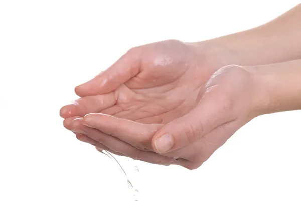 Manos humanas con agua salpicando sobre ellas aisladas en blanco — Foto de Stock