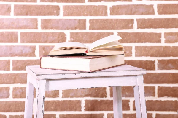 Livros em escada de madeira sobre fundo de parede de cor — Fotografia de Stock