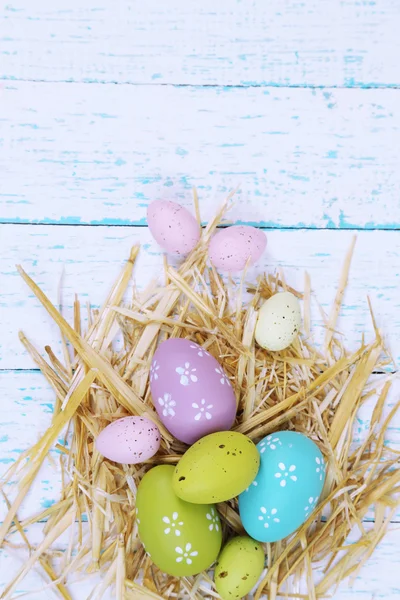 Easter composition with straw on wooden table close-up — Stock Photo, Image