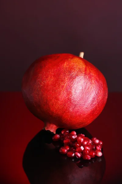 Ripe pomegranate on dark color  background — Stock Photo, Image