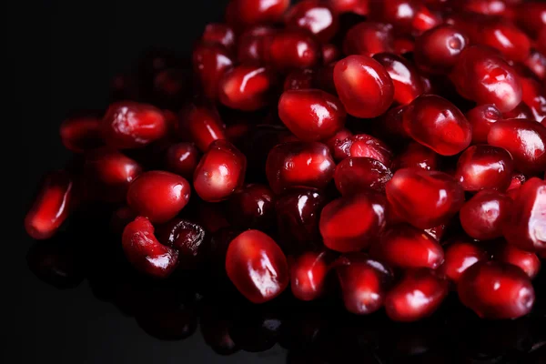 Seeds of pomegranate isolated on black — Stock Photo, Image