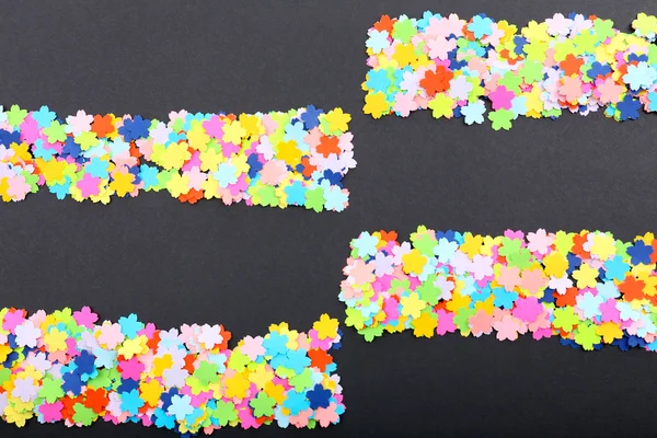 Confetti on black background — Stock Photo, Image