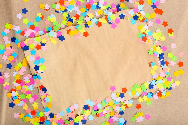 Confetti frame on old paper — Stock Photo, Image