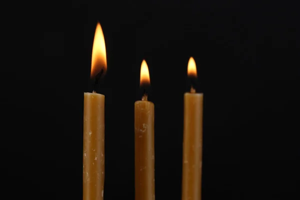 Burning candles on black background — Stock Photo, Image