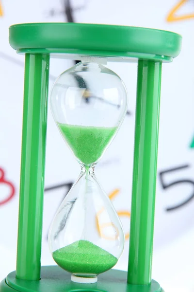 Hourglass on big clock  background — Stock Photo, Image