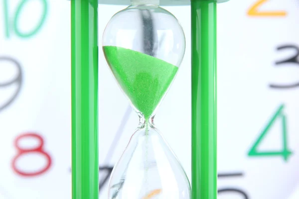 Hourglass on big clock  background — Stock Photo, Image