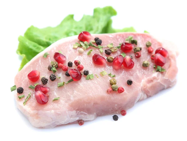 Raw meat steak with leaf lettuce, spices and pomegranate seeds, isolated on white — Stock Photo, Image
