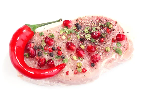 Raw meat steak with herbs, spices and pomegranate seeds, isolated on white — Stock Photo, Image