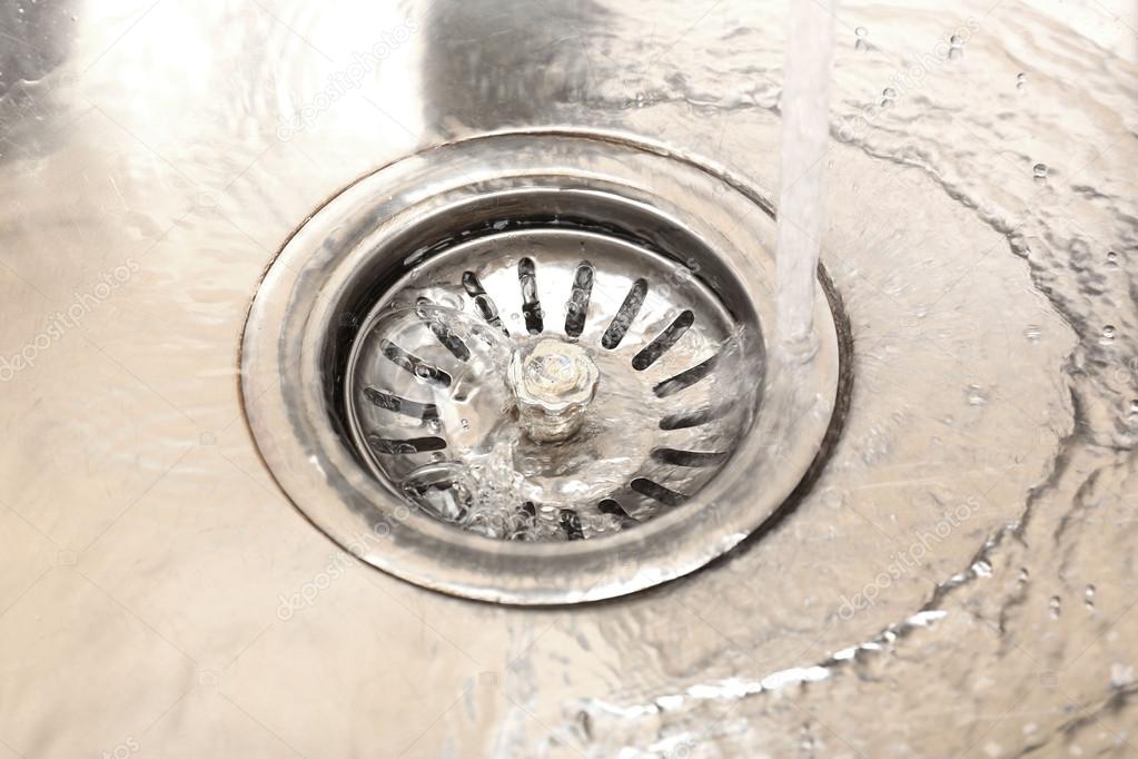 Water flowing down hole in kitchen sink