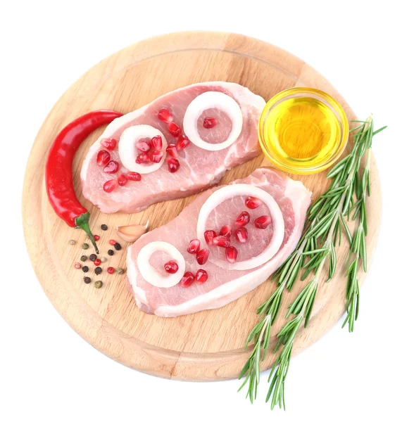 Raw meat steak with herbs, spices, onion rings on cutting board, isolated on white — Stock Photo, Image