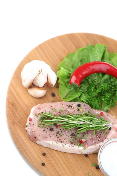 Raw meat steak with herbs and spices on cutting board, isolated on white — Stock Photo, Image