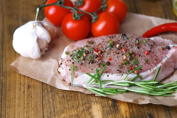 Raw meat steak with spices  herbs, on wooden background — Stock Photo, Image